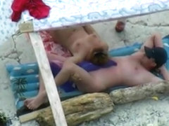 Voyeur tapes a nudist couple having oral sex at the beach