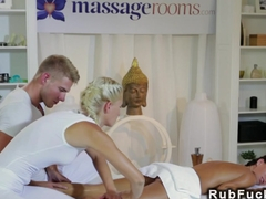 Couple giving massage to sexy brunette
