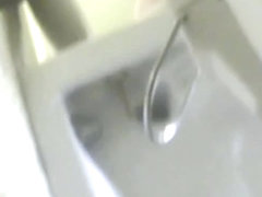 A bikini wearing girl is pissing in beach toilet