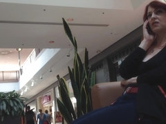Mature woman sitting on mall bench