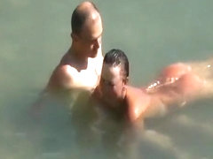 Nudist couple enjoying the fresh water