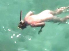 Nudist woman swimming in the water