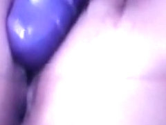wife wearing fishnet nylons rub her clitoris with a purple vibrator