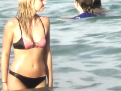 Drunk blond girl gets dirty on beach