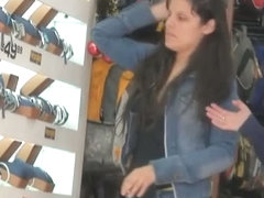 Dark hair sweetie gets filmed by a voyeur as she works in the watch department