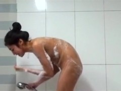 Voyeur tapes a hot asian girl with hairy pussy showering