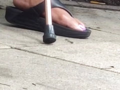 Mature sneaks lotion on feet