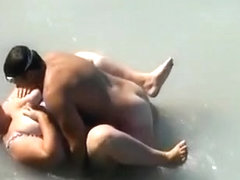 Voyeur busts a bbw with huge tits fucking in the sea