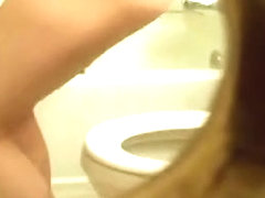 Naked girl with full boobs pissing on toilet getting spied
