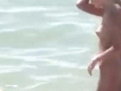 See those smooth nudists play at a public beach