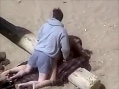 amateur couple having sex on the beach