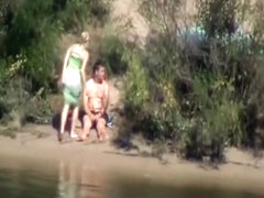 Voyeur tapes a couple having sex in public on the side of the river