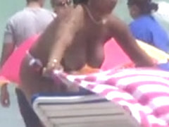 Plump breasted girl caught in a voyeur beach nudism video
