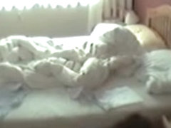 Pantieless girl masturbating pussy slit on the bed