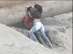 Latino pair caught on the beach