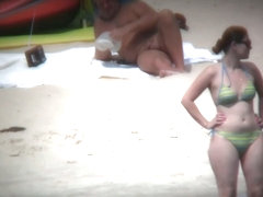 Nude beach voyeur spies on a perky breasted blonde